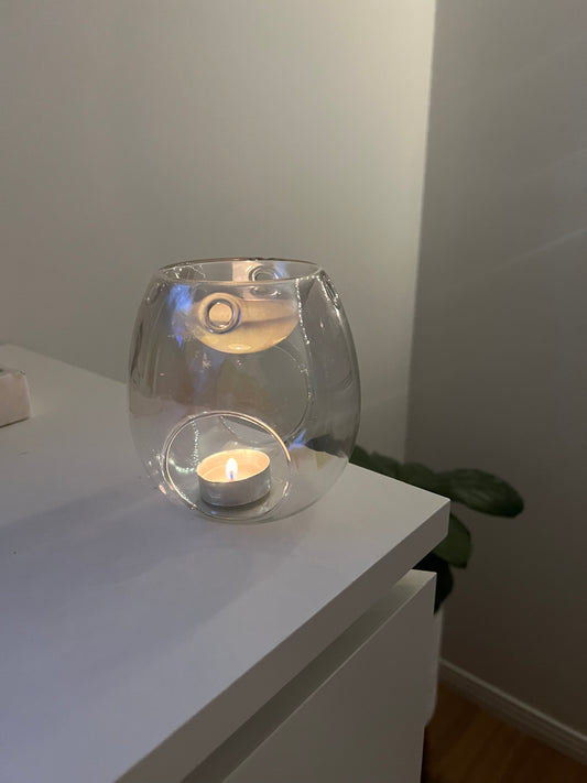 front of pearl glass wax melter with tea light candle burning wax melt